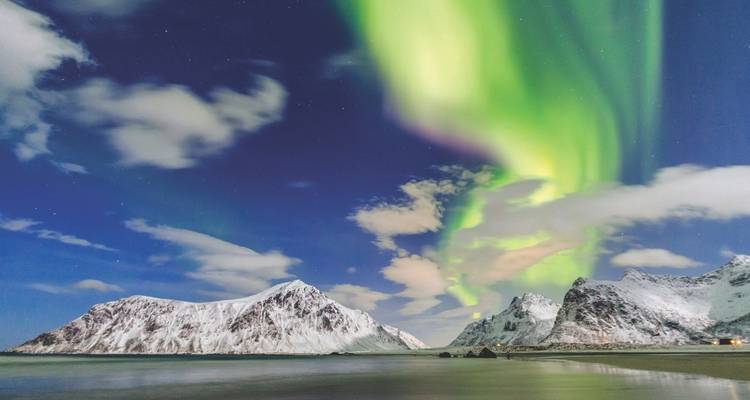 A calm, glassy Nordic fjord reflecting surrounding mountains